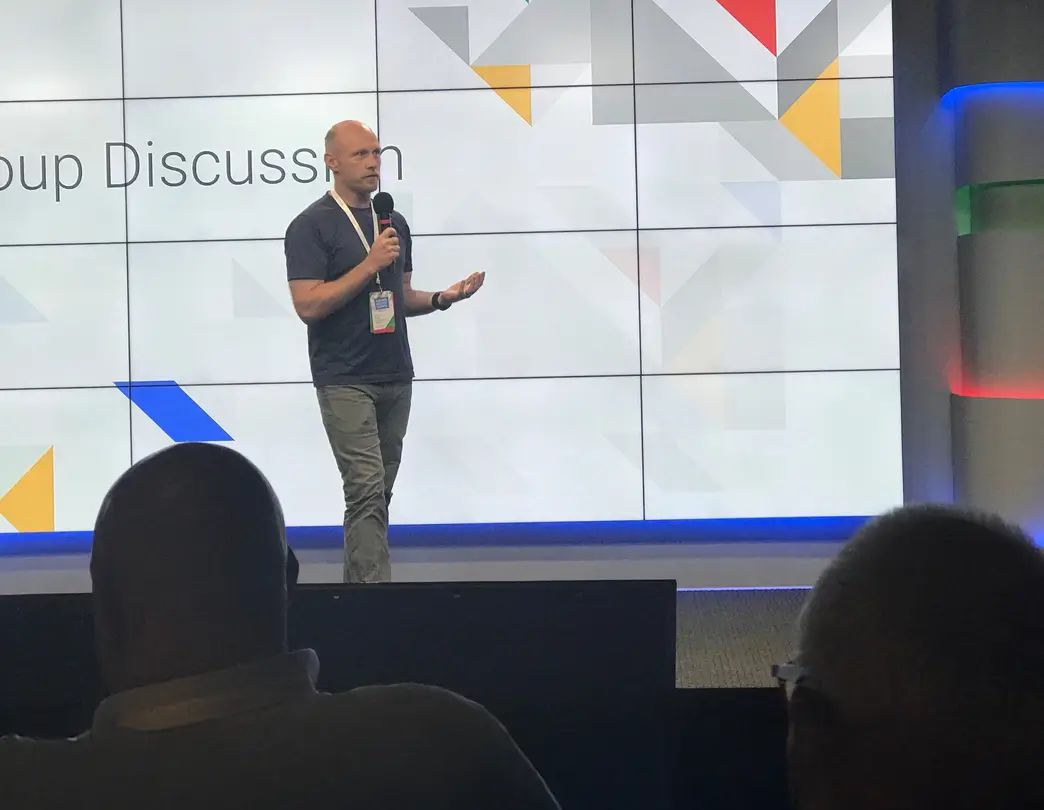 Conrad Saam speaking to a room at a marketing event.